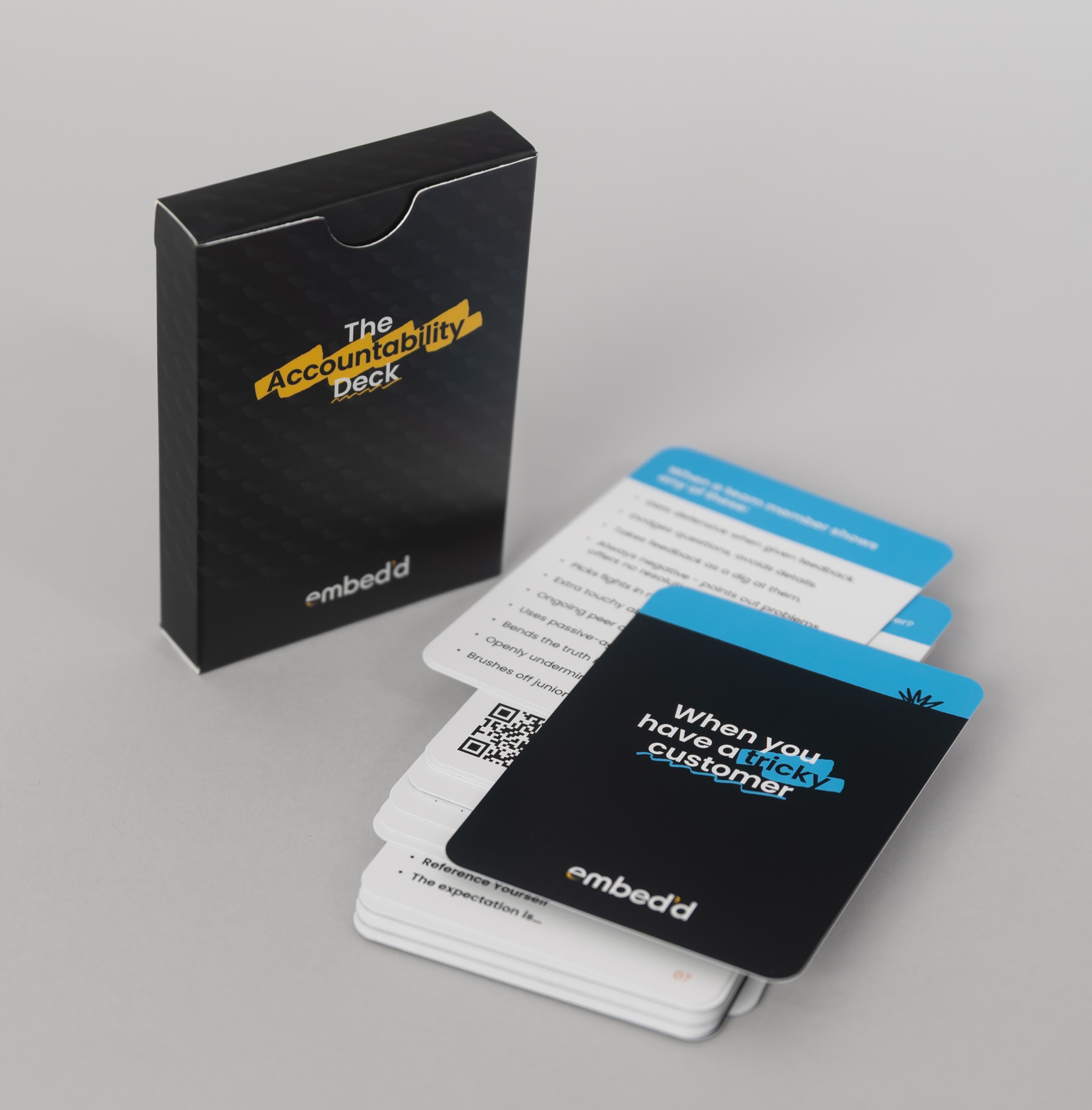 The Accountability Deck box and a spread of practical management cards