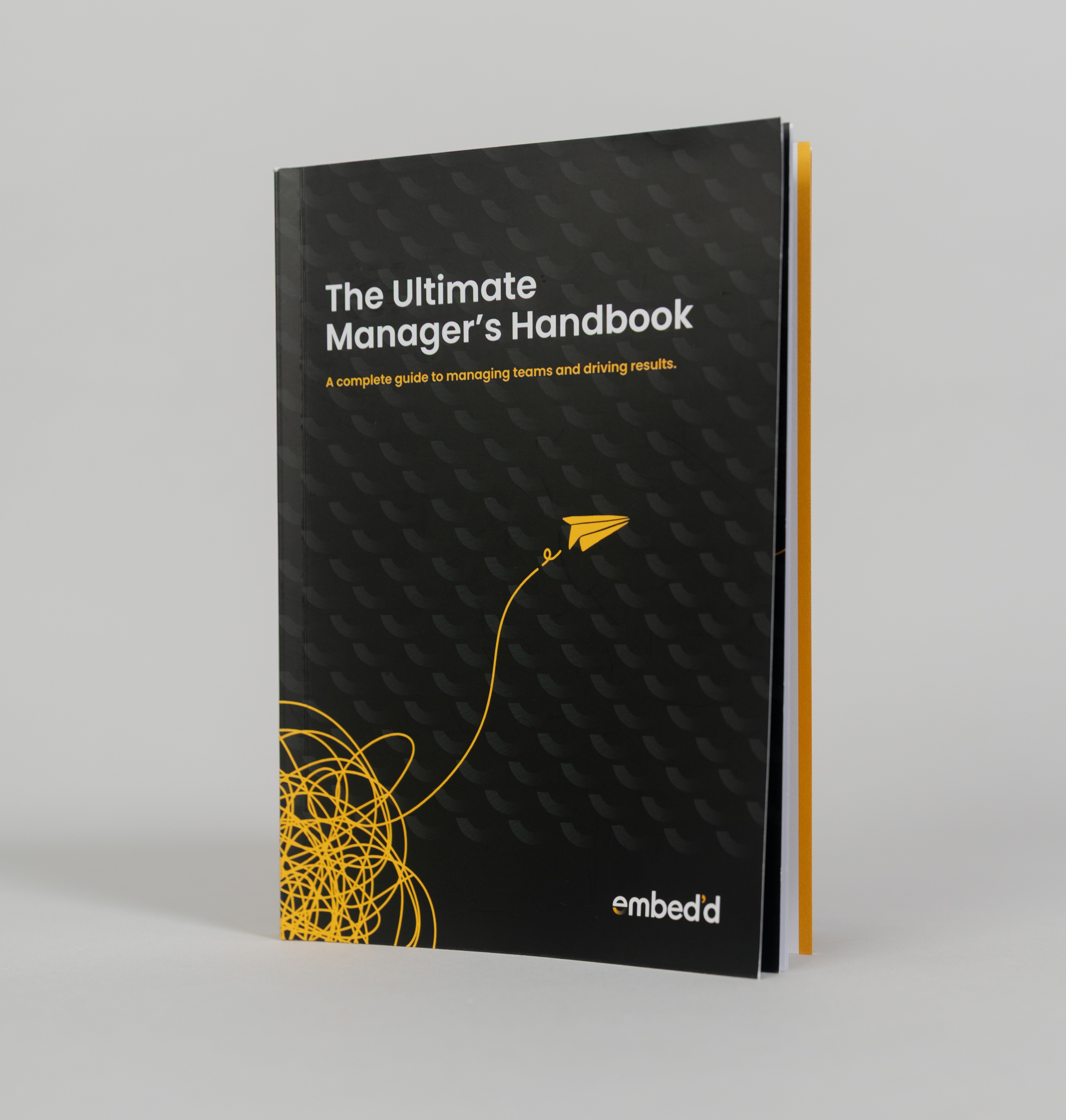 The Ultimate Manager’s Handbook with its black and yellow cover